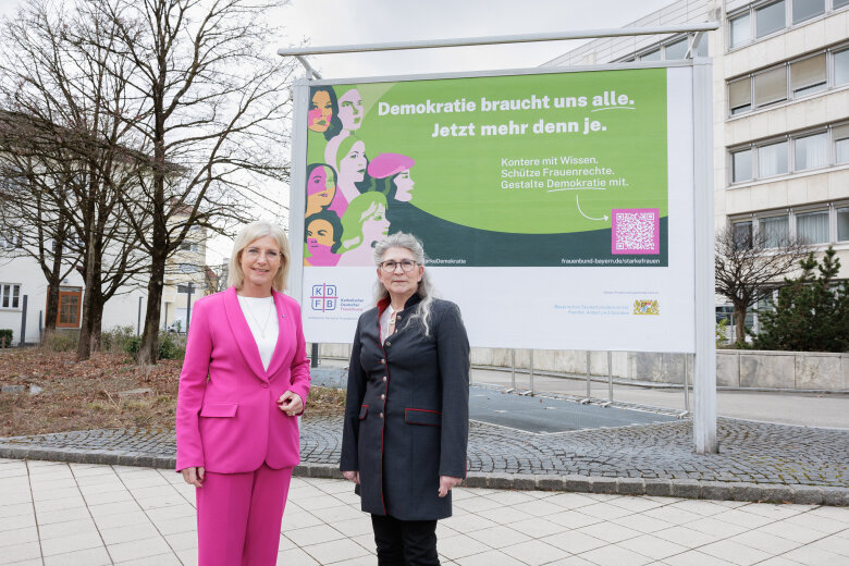 Weltfrauentag 2025 - vor der Plakatwand des Sozialministeriums Frauenministerin Ulrike Scharf (l.) und Birgit Kainz, Landesvorsitzende Bayern des KDFB